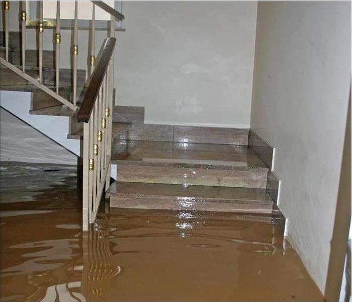Floodwater reaches the stair of a home
